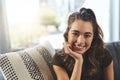 Cherish every moment you spend alone. Portrait of a beautiful young woman relaxing on her sofa at home. Royalty Free Stock Photo