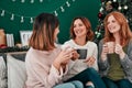 Cherished moments. three attractive women having a coffee on the sofa together at home.