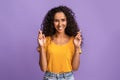 Cherished Wish. Positive Brunette Woman Crossing Fingers And Smiling, Begging For Luck