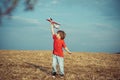 Cherishing memories of childhood. Active children concept. Kid having fun with toy airplane in field. Child pilot Royalty Free Stock Photo