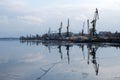 Cherkassy Ukraine January 2021. Cargo cranes in the port of the city of Cherkassy. The Dnieper River covered with ice.