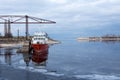 Cherkasy, Ukraine, January 2021. Old abandoned red ship on the ice-covered Dnieper river