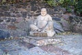 Cherkasy, UKRAINE - OCTOBER 20, 2021 Joyful Buddah concrete grey statue close to White Lotus buddhist temple Royalty Free Stock Photo