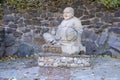 Cherkasy, UKRAINE - OCTOBER 20, 2021 Joyful Buddah concrete grey statue close to White Lotus buddhist temple Royalty Free Stock Photo