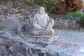 Cherkasy, UKRAINE - OCTOBER 20, 2021 Joyful Buddah concrete grey statue close to White Lotus buddhist temple Royalty Free Stock Photo