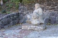 Cherkasy, UKRAINE - OCTOBER 20, 2021 Joyful Buddah concrete grey statue close to White Lotus buddhist temple Royalty Free Stock Photo