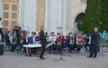 Saxophone soloist and brass band outdoor. Royalty Free Stock Photo