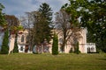 Facade entrance to polish noble Ignacy Witoslawski palace, late afternoon view through park trees, Cherniatyn, Ukraine