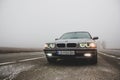 Chernigov, Ukraine - January 6, 2021: Old car BMW 7 Series E38 on the road against a background of fog. Gloomy weather. Bmw and Royalty Free Stock Photo