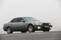 Chernigov, Ukraine - January 6, 2021: Old car BMW 7 Series E38 on the road against a background of fog. Gloomy weather. Bmw and Royalty Free Stock Photo