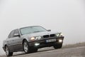 Chernigov, Ukraine - January 6, 2021: Old car BMW 7 Series E38 on the road against a background of fog. Gloomy weather. Bmw and Royalty Free Stock Photo