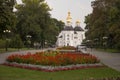 Chernigov, Ukraine. September 15, 2017. Christian orthodox white church with grey domes and gold crosses. Park with flowers. Calm Royalty Free Stock Photo