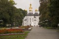 Chernigov, Ukraine. September 15, 2017. Christian orthodox white church with grey domes and gold crosses. Park with flowers. Calm Royalty Free Stock Photo
