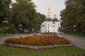 Chernigov, Ukraine. September 15, 2017. Christian orthodox white church with grey domes and gold crosses. Park with flowers. Calm Royalty Free Stock Photo