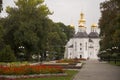 Chernigov, Ukraine. September 15, 2017. Christian orthodox white church with grey domes and gold crosses. Park with flowers. Calm Royalty Free Stock Photo