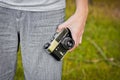 Chernihiv, Ukraine - July 26, 2019: A guy holds an old camera in his hand Royalty Free Stock Photo