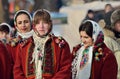 Young hucul woman performs Malanka song during ethnic festival of Christmas Carols in open-air museum of folk architecture,Ukraine