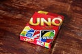 Chernivtsi, Ukraine - July 3, 2018:Uno game box. Very popular game in a box on a wooden background Royalty Free Stock Photo