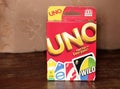 Chernivtsi, Ukraine - July 3, 2018:Uno game box. Very popular game in a box on a wooden background Royalty Free Stock Photo