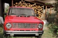 Chernivtsi, Ukraine - September 13, 2018: Old Russian car VAZ 2101. Red old car on a background of firewood Royalty Free Stock Photo