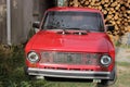 Chernivtsi, Ukraine - September 13, 2018: Old Russian car VAZ 2101. Red old car on a background of firewood Royalty Free Stock Photo