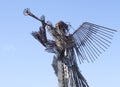 Metal sculpture of a trumpeting angel against the blue sky in Chernobyl. Monument to the