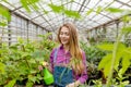 Cherrful girl spending ime at greenhouse