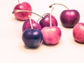 Cherries with artificial, surreal, unnatural, look isolated on bright background.