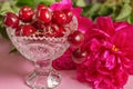 Cherries in the beautiful crystal vase with peony