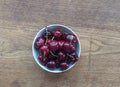 Cherries in a bowl close-up on wooden table top view. Copy space. Summer concept. Organic berries. Royalty Free Stock Photo