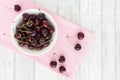 Cherries in a Bowl on Pink Fabric and White Wood Royalty Free Stock Photo