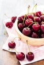 Cherries in bowl on a wooden table Royalty Free Stock Photo
