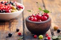 Cherries in a bowl on a wooden table Royalty Free Stock Photo