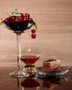 Cherries, brandy and a piece of chocolate cake Royalty Free Stock Photo