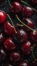 Cherries covered in water droplets against a dark background look very appetizing and tempting.