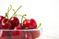 Cherries in glass dish. Cherry on wood and white background. - healthy eating and food concept Royalty Free Stock Photo