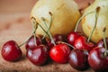 Cherries and pear, fresh fruits on wooden table