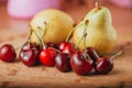Cherries and pear, fresh fruits on wooden table