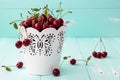 Cherries in a small white bucket on old vintage wooden background. Royalty Free Stock Photo