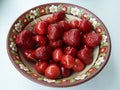 Cherries and strawberries in a ceramic bowl