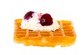 Cherries and whipped cream on freshly baked waffle brightened