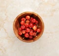 Cherries in a wooden bowl on a marble background Royalty Free Stock Photo