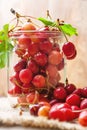 Cherries on wooden table in glass jar Royalty Free Stock Photo