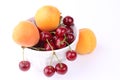 Cherry and apricot in ceramic bowl isolated on white background Royalty Free Stock Photo