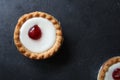 Cherry bakewell tarts in foil cases on dark background Royalty Free Stock Photo