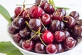 Cherry berries in a bowl on a white background. Fresh cherries. The concept of a healthy diet and support for local producers. Clo Royalty Free Stock Photo