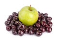 Cherry berries and one big green apple on white background isolated close up macro