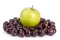 Cherry berries and one big green apple on white background isolated close up macro