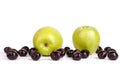 Cherry berries and two big green apples on white background isolated close up macro Royalty Free Stock Photo