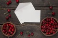 Fresh cherries on a wooden board woth empty present card background on a wooden table Royalty Free Stock Photo